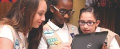 cadette girl scouts looking at computer