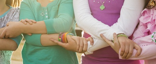 troop-hero Girl Scouts standing in a friendship circle