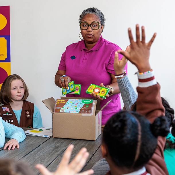 Four girls holding hands in a friendship circle