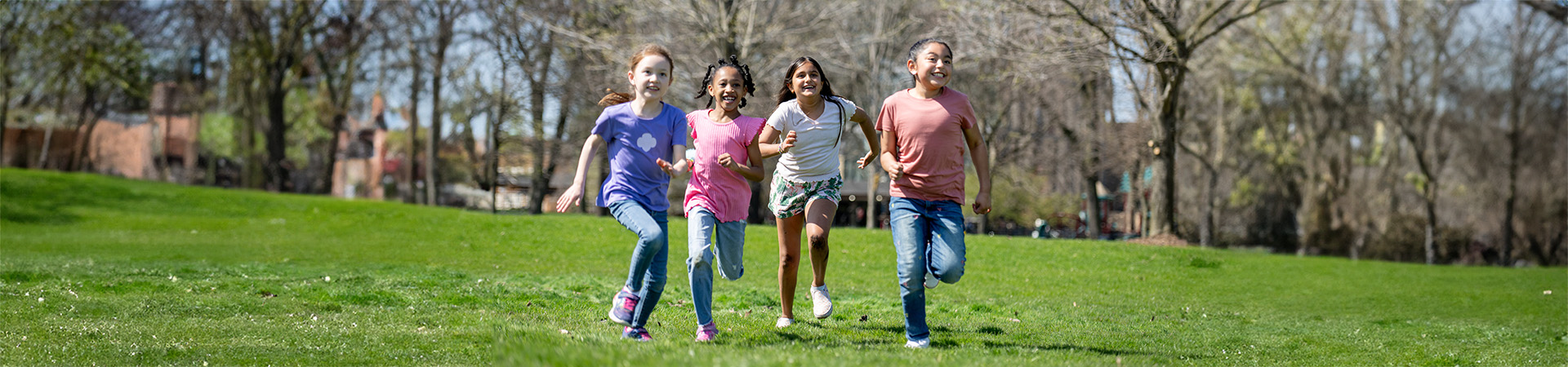  Group of Junior Girl Scouts smiling and laughing outdoors 