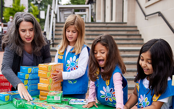 Three Girl Scouts counting change.