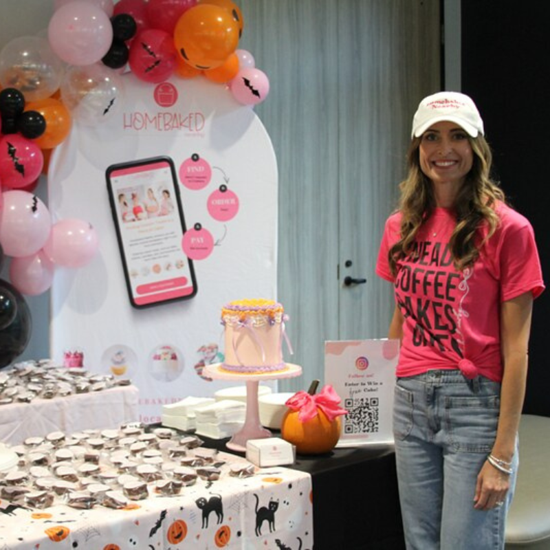 Woman in hat smiling in front of cake and pastries